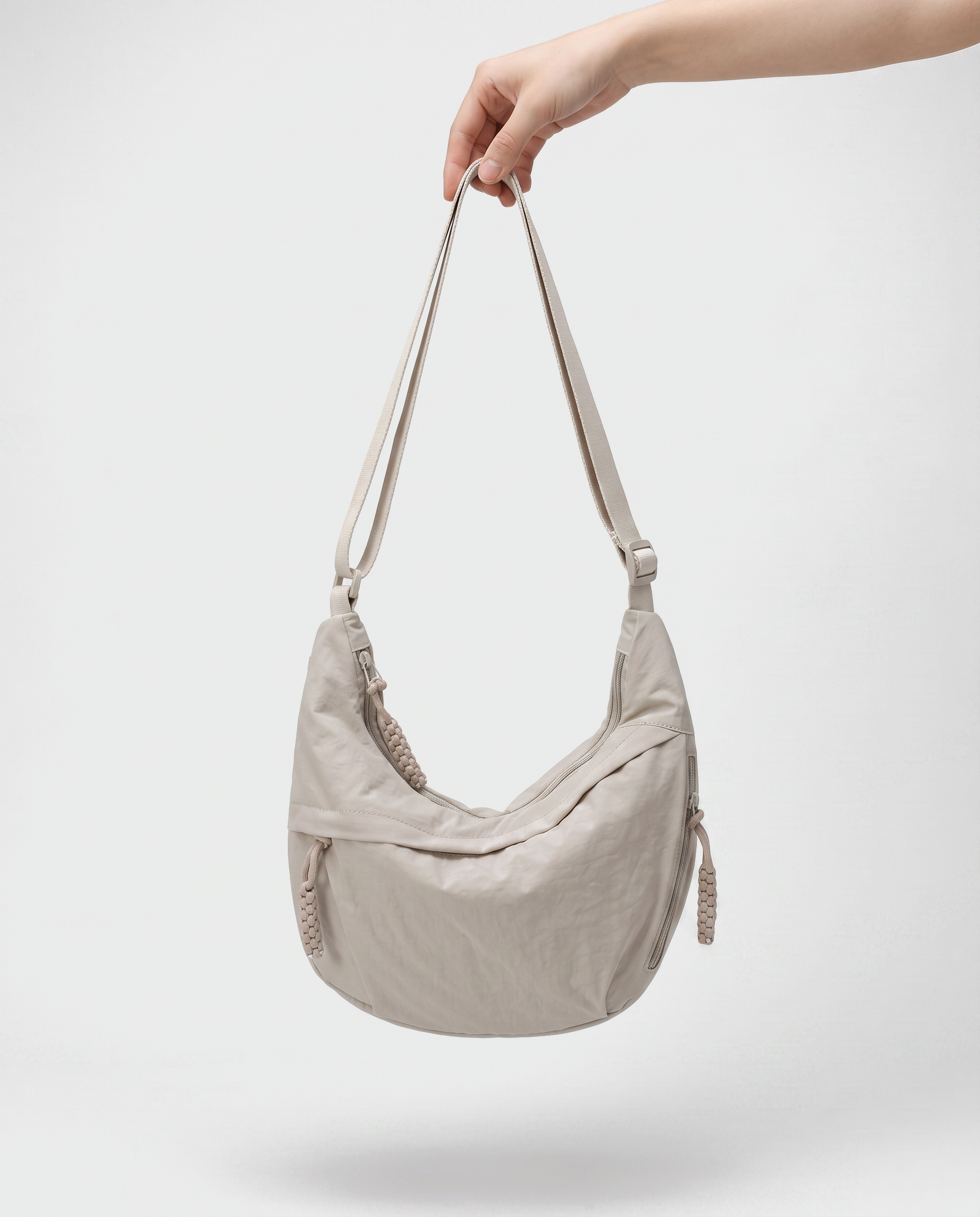 all-groups - The Agathe Crossbody, held by the strap, showing how light it is at 180 g