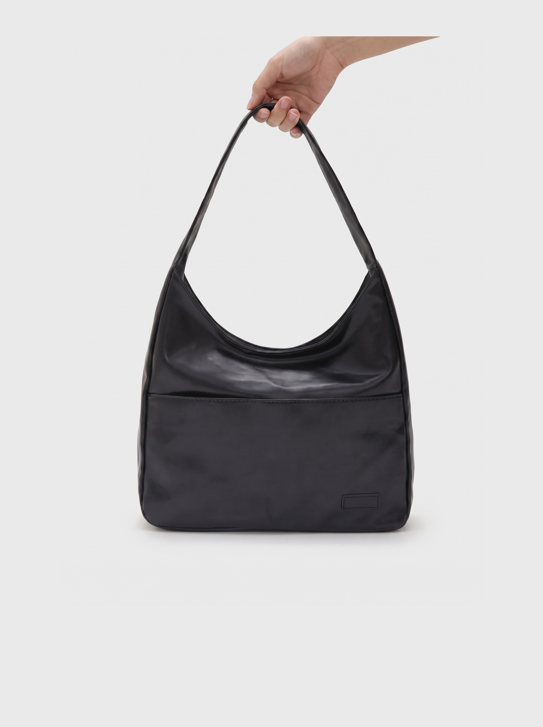 all-groups - The Honorine Hobo, held by the handle, showing its light soft body